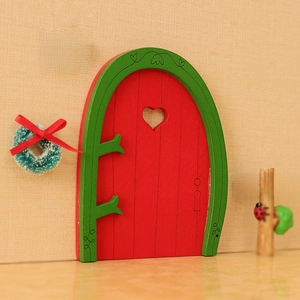 Miniature red wooden Christmas dollhouse door with wreath and Santa Claus sign decor