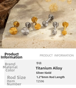 Detailed view of titanium labret stud with sunburst design in gold and silver, 1.2x8mm
