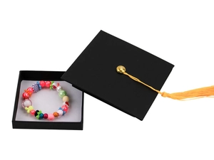 Detail of graduation gift set with colorful beaded bracelet and black mortarboard box