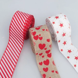 Three rolls of Christmas burlap ribbons with stripes, hearts, and stars for DIY crafts