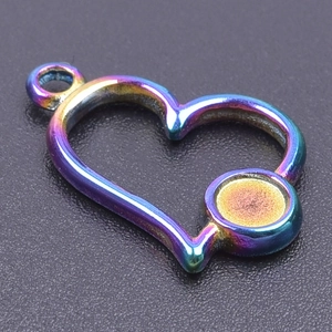 Macro shot of a hollow rainbow heart-shaped metal pendant for DIY jewelry design