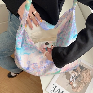 Detail view of large canvas shoulder bag interior with floral print and magnetic clasp