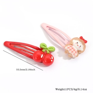Detail view of cute 55mm cherry and doll hair clips with size and weight specs
