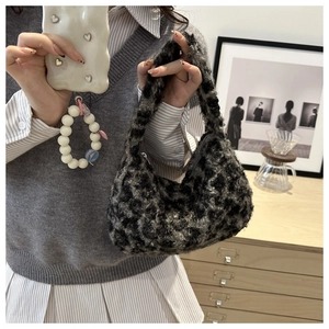Leopard print plush shoulder bag shown on model for size reference and daily style