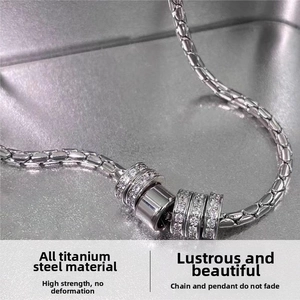 Detail of silver titanium steel necklace with five sparkling zircon-encrusted rings