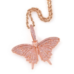 Macro detail of rose gold butterfly pendant with pink pave-set cubic zirconia on rope chain