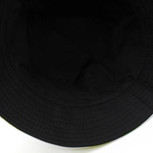 Close-up of internal stitching and twill lining on a black tropical print bucket hat