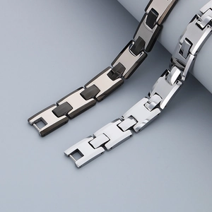 Detail view of two-tone black and silver stainless steel H-link chain bracelets