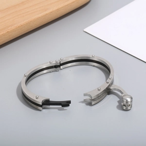 Industrial titanium steel bracelet with black carbon fiber inlay and stud details