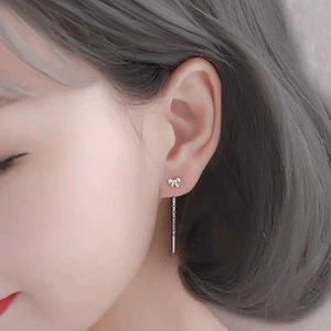 Elegant S999 sterling silver bow tassel earrings on model showing minimalist Korean style