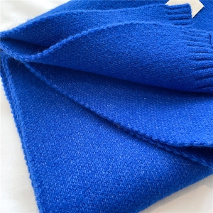 Close-up of bright blue knitted scarf showing soft wool texture and ribbing detail