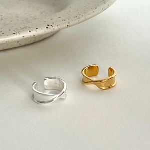Close-up of gold and silver S925 sterling silver rings with geometric folded design