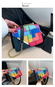 Detail of black leather square bag featuring colorful geometric patterns and gold chain