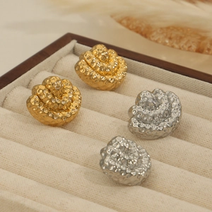 Hammered 18K gold and silver camellia rose stud earrings in a luxury velvet jewelry box