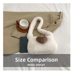 Size comparison of white faux fur shoulder bag with heart pattern next to a smartphone