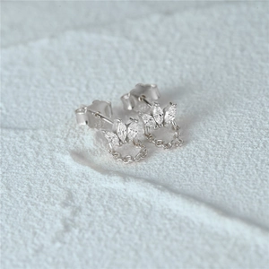Macro shot of S925 sterling silver crown earring with marquise stones and fringe chains
