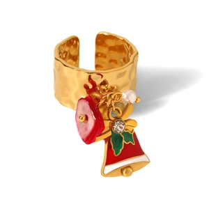 Detail view of 18k gold Christmas ring with bell, pearl and zircon charms on hammer texture