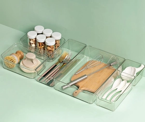 Transparent drawer organizers showing various sizes for kitchen tools and accessories