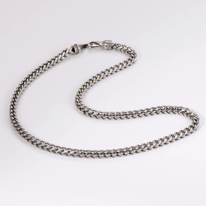 Detailed view of silver braided stainless steel chain with a durable lobster clasp