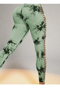 Detail of high waist tie-dye yoga pants with cutout side lace-up design and butt lift effect