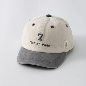 Close-up of color-block cotton baseball cap featuring embroidered number 7 and grey brim