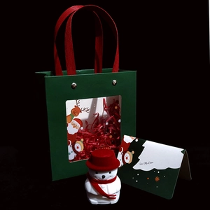 Detail of green Christmas gift bag with plush snowman and For My Dear greeting card