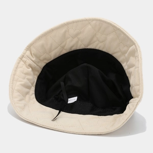 Beige quilted bucket hat with heart patterns and adjustable inner sweatband strap