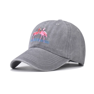 Close-up of pink flamingo embroidery on vintage grey washed denim baseball cap