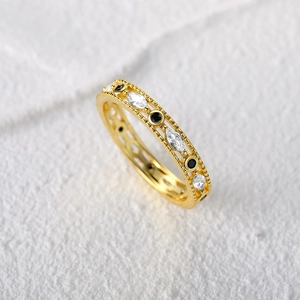 Detail of vintage gold ring with marquise cubic zirconia and black gemstone stones