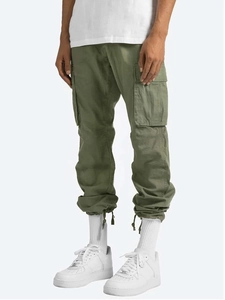Detail view of cargo pants featuring side utility pockets and adjustable drawstring cuffs