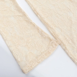 Close-up of beige lace dress detailing with floral rose embroidery and hollow texture