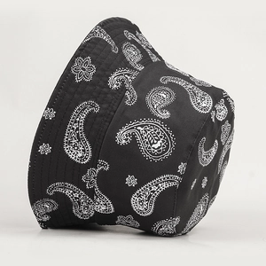 Black reversible paisley bucket hat with white pattern for sun protection and street style