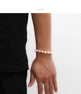 Close-up of baroque freshwater pearl bracelet with gold beads worn on a wrist