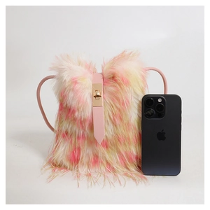 Plush faux fur crossbody bag in pink and yellow gradient shown beside a smartphone for size