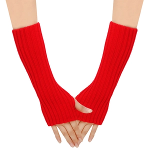 Detail of red cable knit fingerless arm warmers showing thick vertical ribbed texture