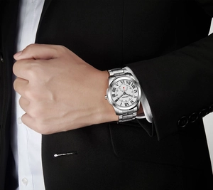 Silver stainless steel business watch with Roman numeral dial on a male wrist