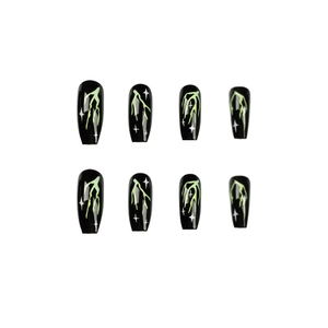 Cool black press-on nails with neon green lightning and white star patterns