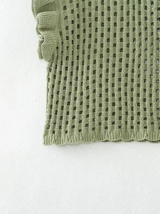 Detailed macro view of green knit mesh top with delicate ruffle sleeves and lace texture