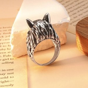 Vintage silver wolf head ring for men with detailed engraving on a white stone background