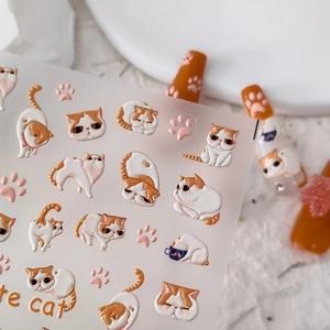 3D embossed nail art stickers featuring cute orange and white cats with paw prints