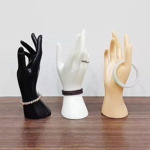 Three-color female hand models in black white and nude showing rings and bracelets