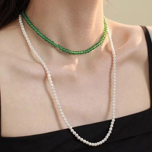 Layered pearl and green agate necklace set on model, elegant neo-vintage style choker
