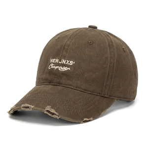 Dettaglio cappello baseball marrone in cotone con ricamo vintage e visiera usurata
