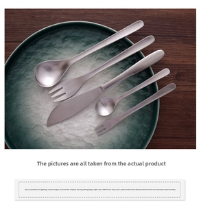 Detailed top view of 5-piece matte 304 stainless steel cutlery set on a dark plate