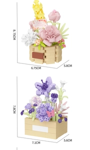 Detailed view of artificial pink rose and purple flower building blocks in mini pots