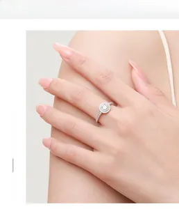 Macro view of a 925 sterling silver halo ring with pavé diamonds on a model's hand