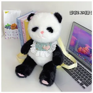 Detail of panda plush backpack with fluffy texture and lace bib in a cozy home desk setup