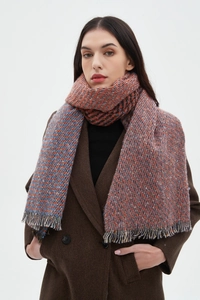 Detail shot of heavy woven scarf with fringes and red-brown and blue patterns
