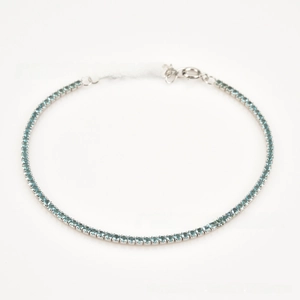 Macro detail of S925 sterling silver tennis bracelet with round cut light blue zircons