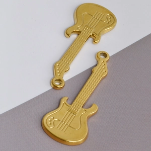 Detail of two golden guitar pendants made of 304 stainless steel for DIY jewelry making